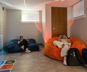 Cooper Ganfield hall sensory room with two students sitting on bean bag chairs 